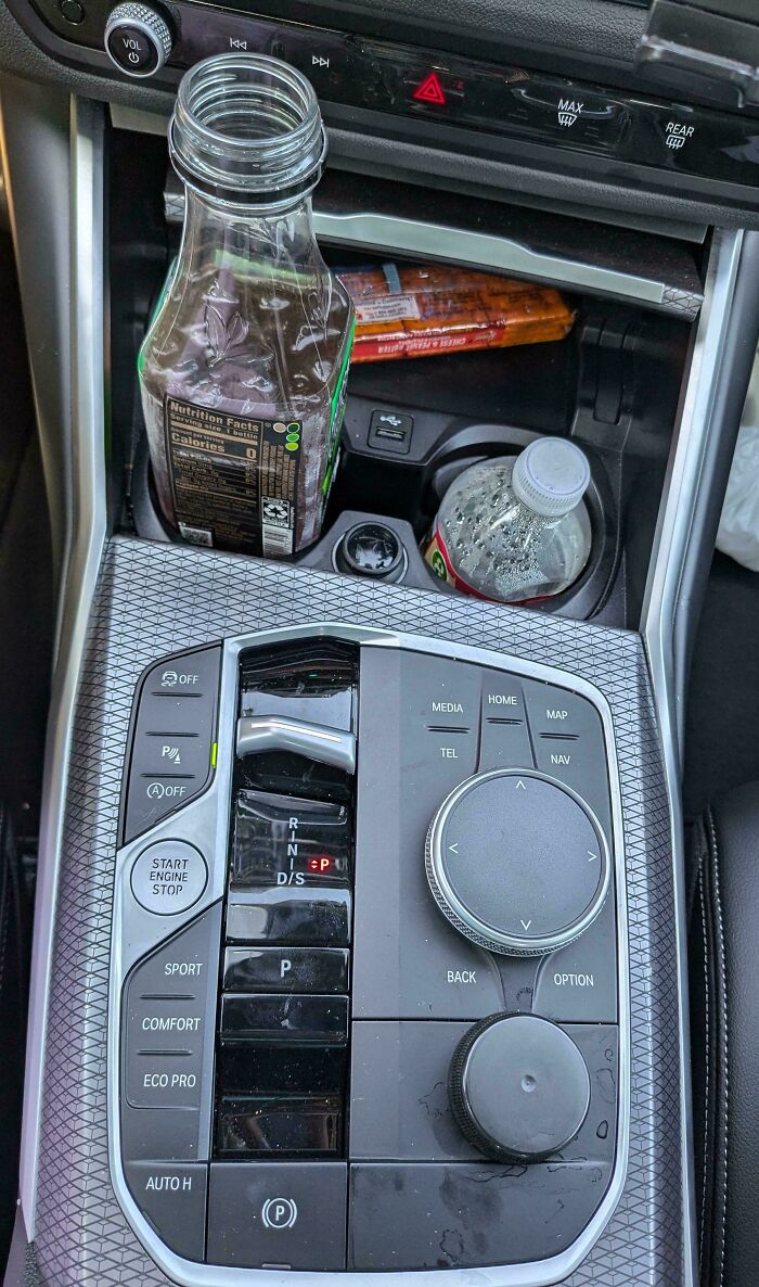 Car console with a juice bottle seamlessly merged into the background design.