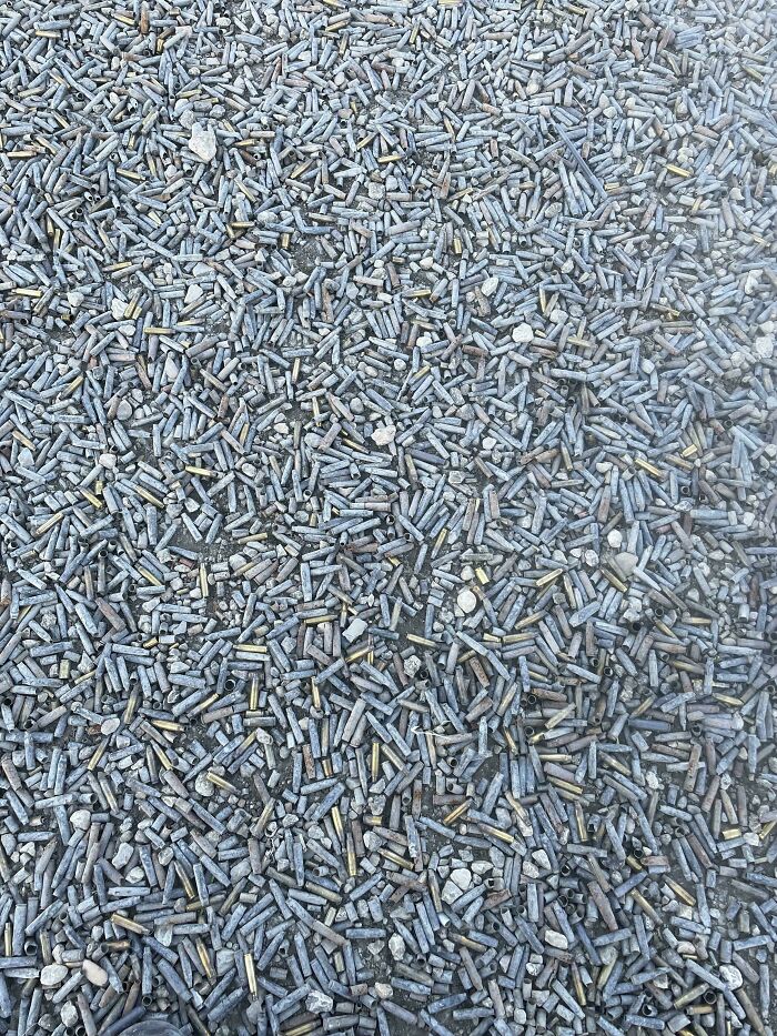 Bullets seamlessly merged into a gravel background, creating a camouflaged effect.