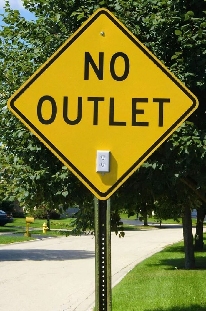 Yellow no outlet street sign with an electrical outlet attached below the text, combining science and humor in a meme.