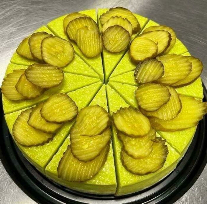 Pickle-topped bright green cheesecake, showcasing one of the unusual dishes for the list.