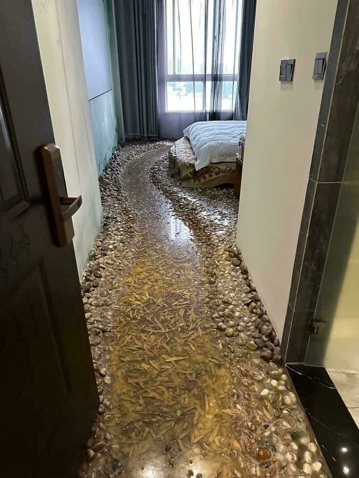 Bedroom with a pebble and leaf floor design illustrating a unique but questionable DIY disaster project.