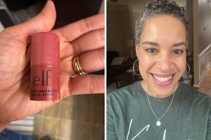 Hand holding e.l.f. Monochromatic Multi-Stick; smiling person wearing hoop earrings and a green shirt indoors.