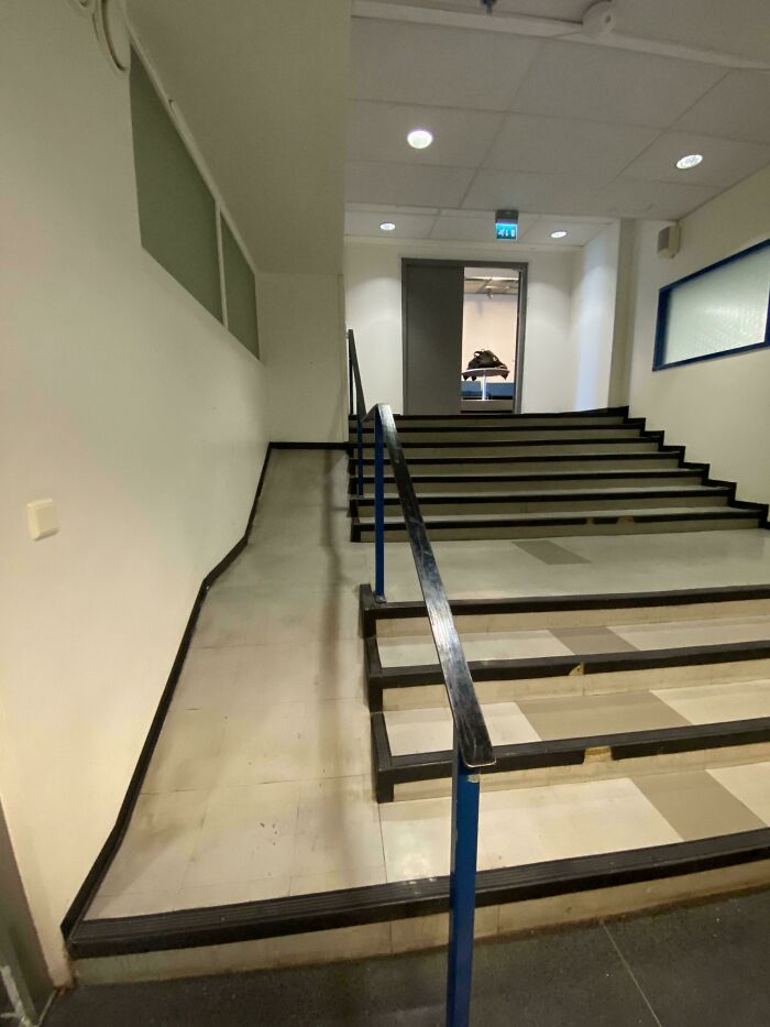 Indoor stairway with a wheelchair ramp blocked by several steps causing a perfect preventable fail.