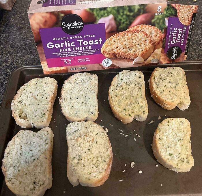 Unbaked garlic toast slices on a baking tray showing a perfectly preventable food fail.