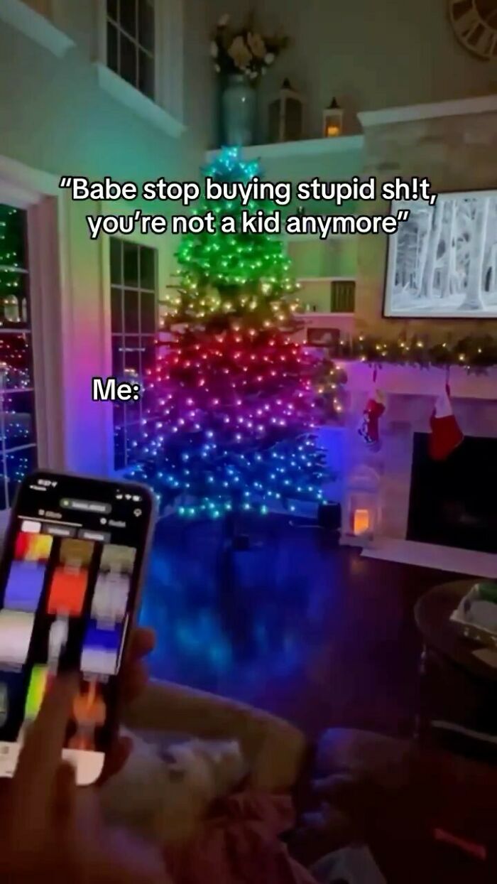 Colorful Christmas tree lit with rainbow lights in living room, humor caption from hilarious tweets on social media.
