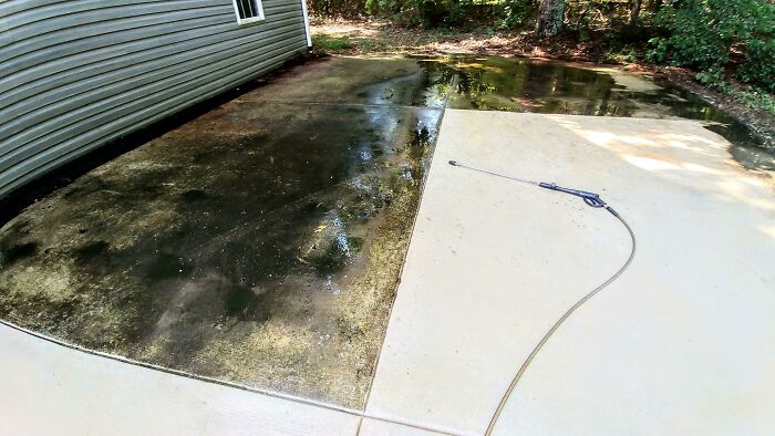 Power washed driveway showing a dramatic before and after, highlighting the satisfying cleaning results.