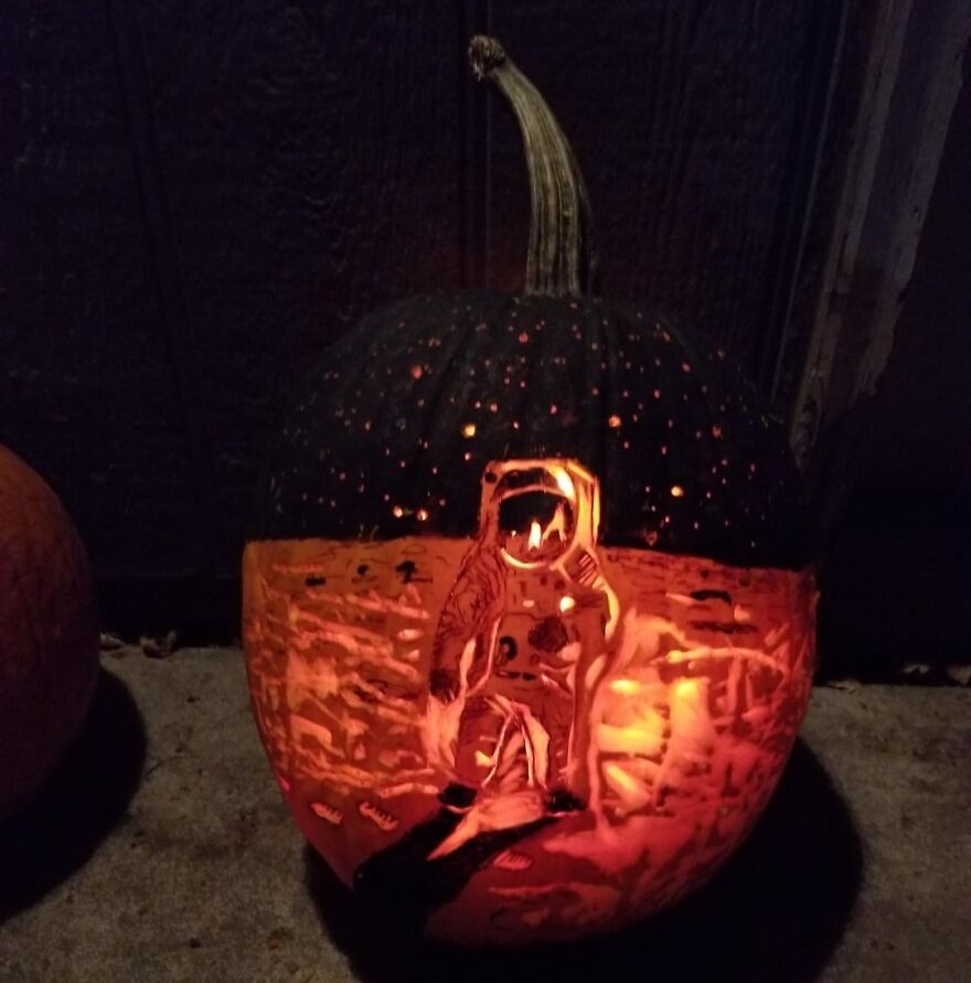 Pumpkin carving of an astronaut on the moon with stars, showcasing a spooky and quirky pumpkin carving design.