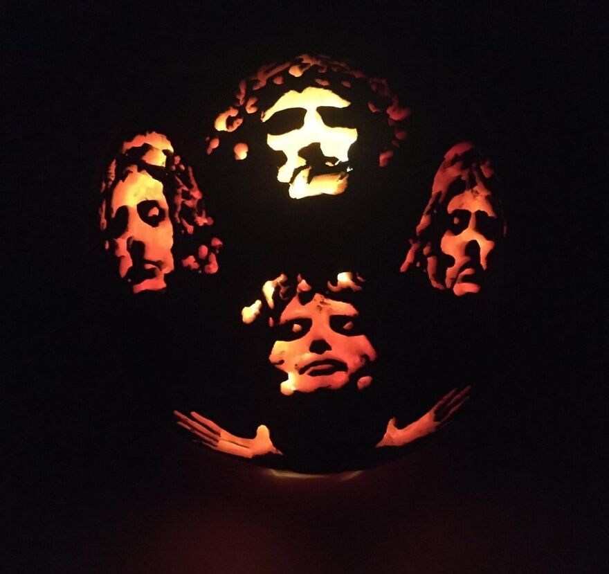Pumpkin carving featuring detailed faces illuminated from within, showcasing quirky and spooky pumpkin carvings art.