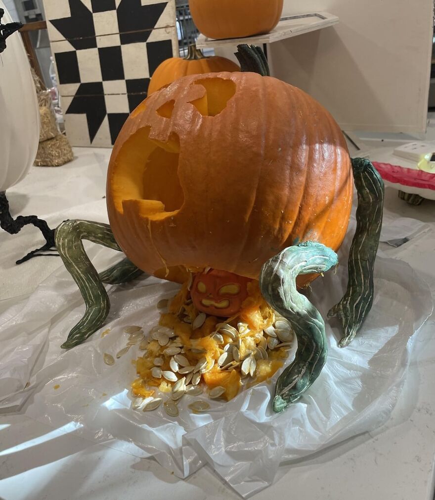 Pumpkin carving with tentacle-like vines and a smaller face inside, showcasing quirky and charming pumpkin carvings online.