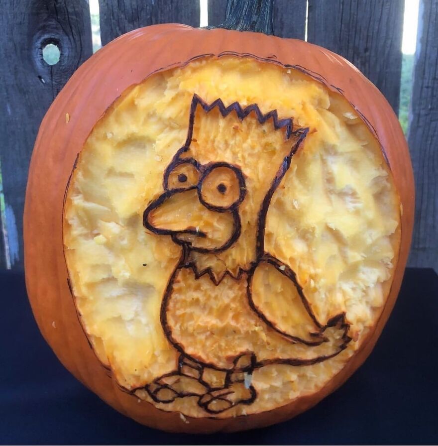Pumpkin carving of Bart Simpson bird character with detailed scraping and outlined design showcased outdoors on a black surface.