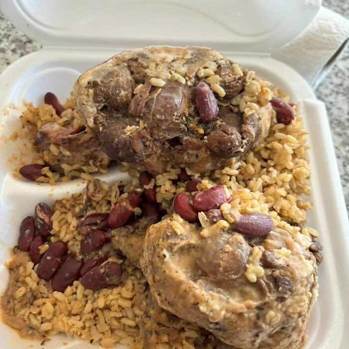 Unappetizing food photo: rice and beans with meat in a takeout container.
