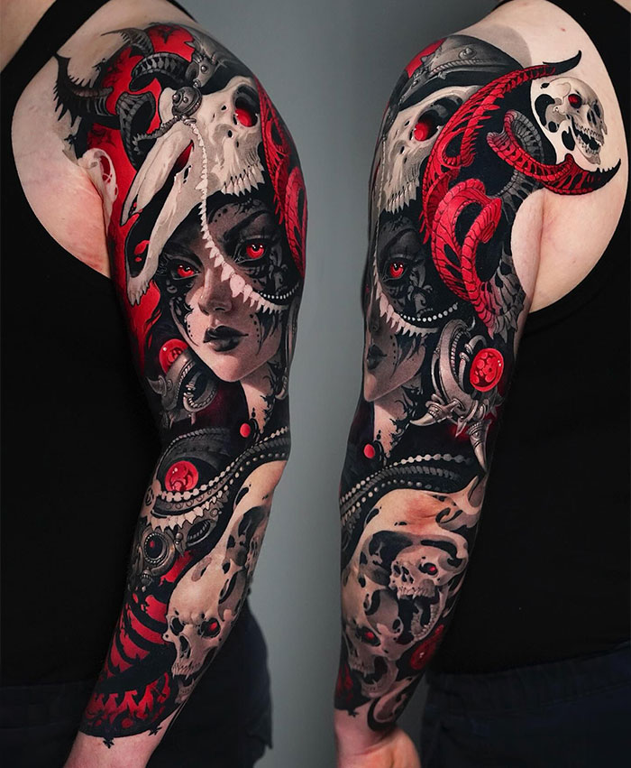  A detailed full-sleeve tattoo featuring dark, gothic themes with a combination of skulls, a woman's face, and intricate patterns. The design is highlighted by bold red accents and surreal elements, creating a dramatic, striking look. Tattoo ideas for men that incorporate dark fantasy, realism, and vibrant colors for a visually impactful sleeve.