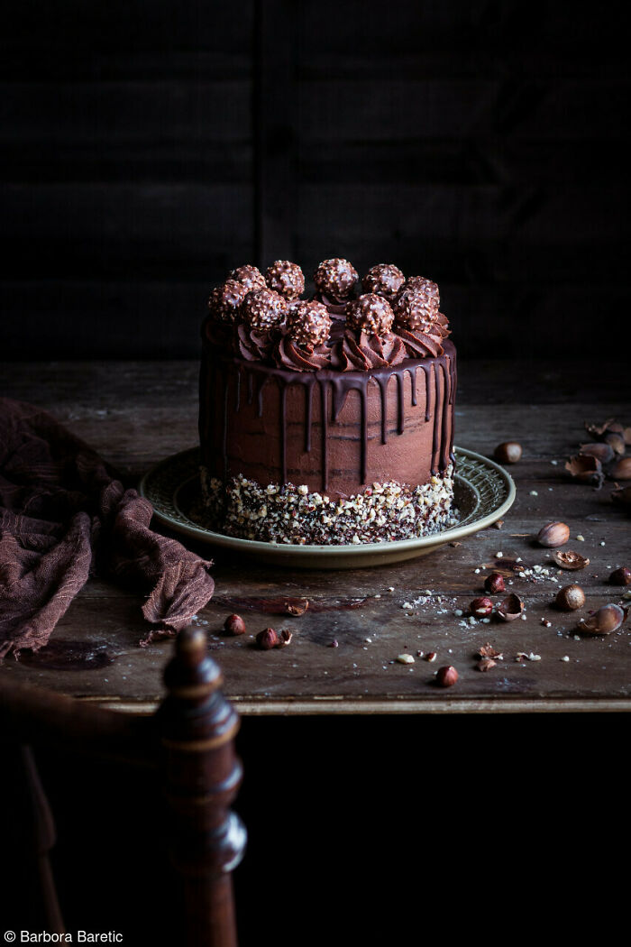 Chocolate cake with ganache and hazelnut topping on a table, celebrating National Cake Day with Tiptree Cake Awards.
