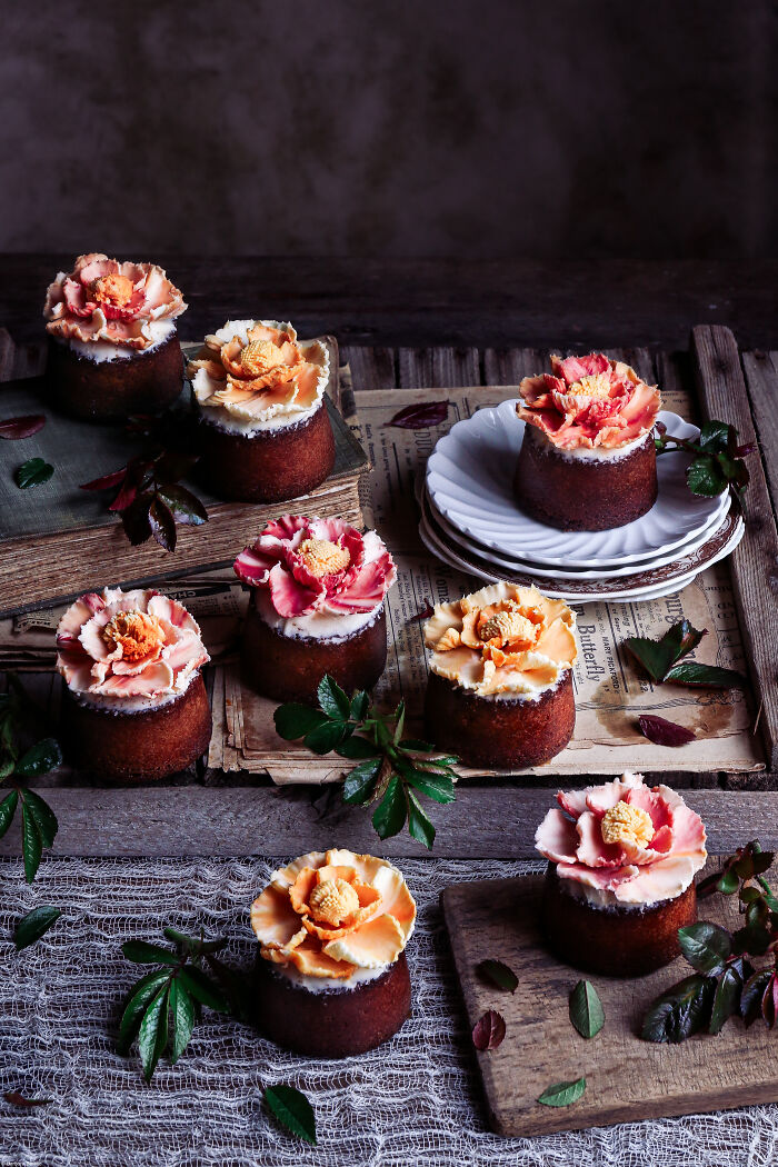 Decorative cakes with flower toppings displayed for Tiptree Cake Awards celebration.