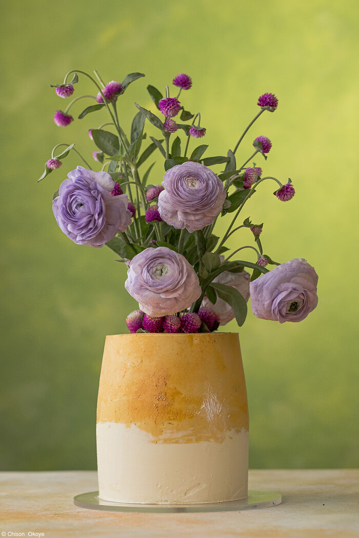 Elegant cake adorned with purple flowers, celebrating National Cake Day with Tiptree Cake Awards.