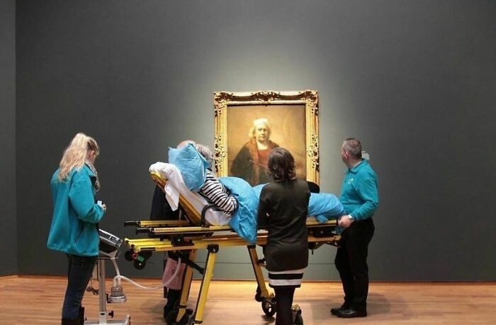 A patient on a stretcher in an art gallery being moved by staff, among delightfully random photos to brighten your day.