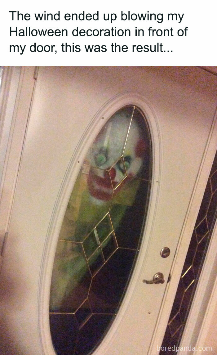 Clown Halloween decoration stuck in front door, creating a hilarious meme.