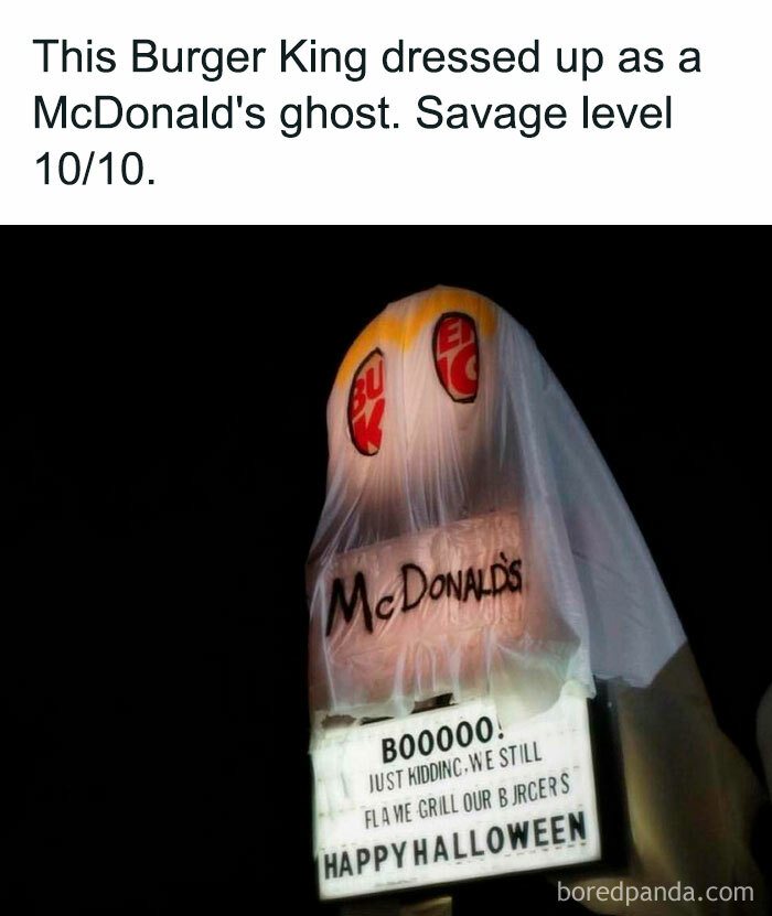 Burger King sign dressed as McDonald's ghost, humorously celebrating Halloween.
