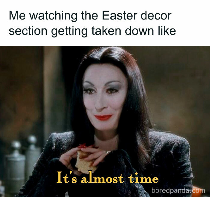 A woman in black with dark hair smiling, holding a sandwich, with text: "It's almost time." Halloween memes theme.