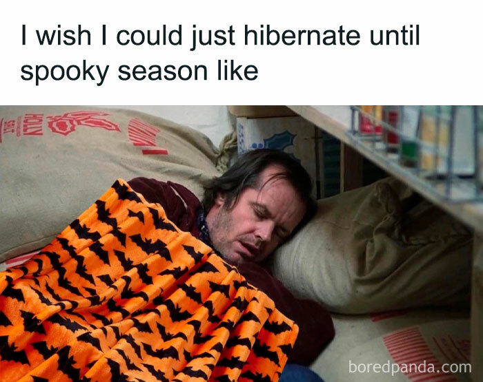 Man sleeping under a Halloween-themed blanket with pumpkin design, capturing a humorous Halloween meme vibe.