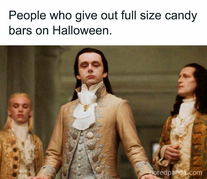 Elegant men in historical attire humorously depict Halloween meme about generous candy givers.