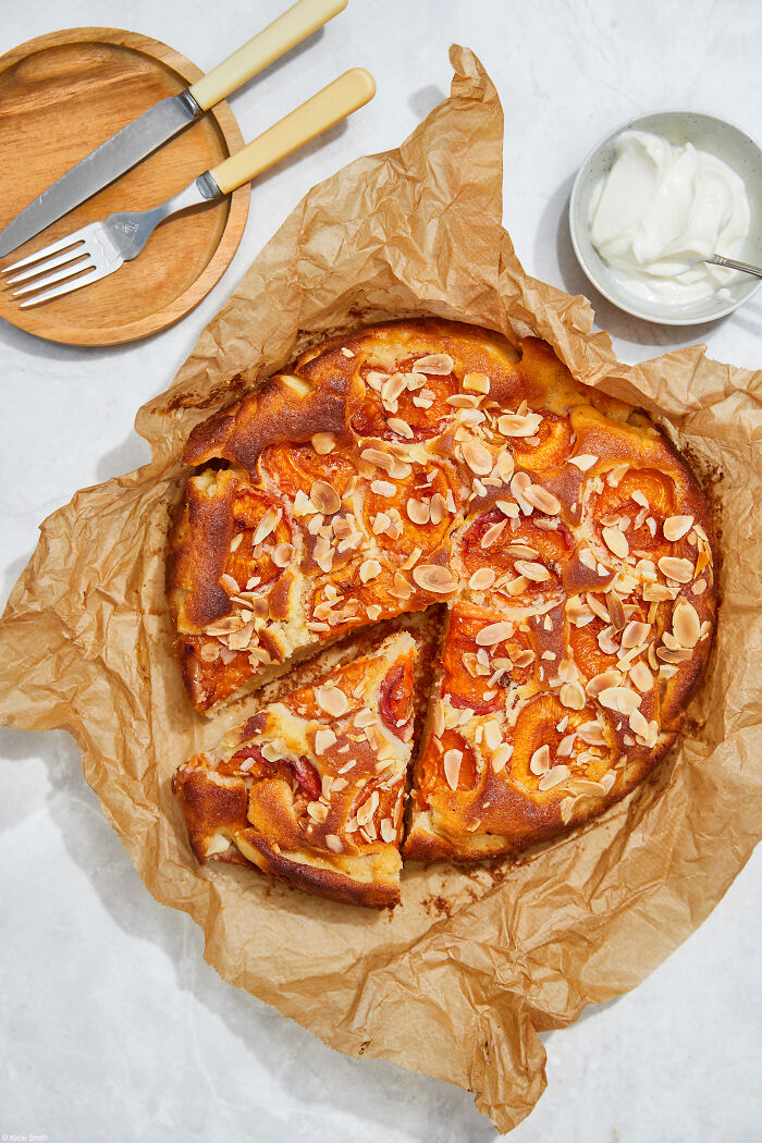 Almond-topped cake on parchment, celebrated by photographers worldwide for National Cake Day and Tiptree Cake Awards.