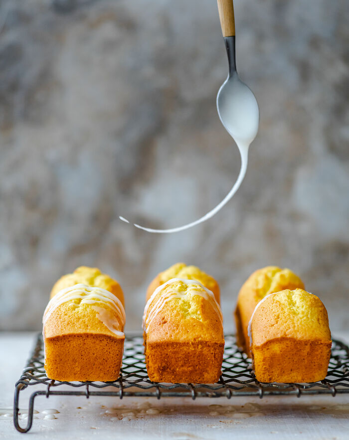 Mini cakes on a wire rack, drizzled with icing, representing Tiptree Cake Awards celebration.