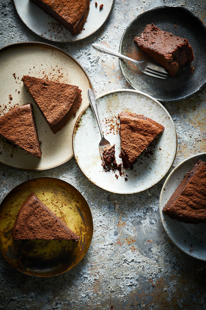 Chocolate cakes on rustic plates, celebrating National Cake Day with Tiptree Cake Awards.