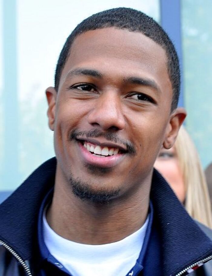 Smiling actor in a blue shirt and jacket outdoors, related to actors' impact in films.