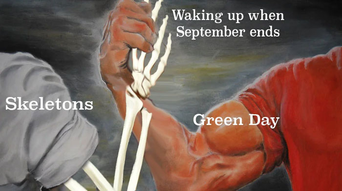  An October meme showing a handshake between a skeleton and a muscular arm. The labels read "Skeletons" and "Green Day," with "Waking up when September ends" above, humorously connecting the band’s song to the arrival of October.