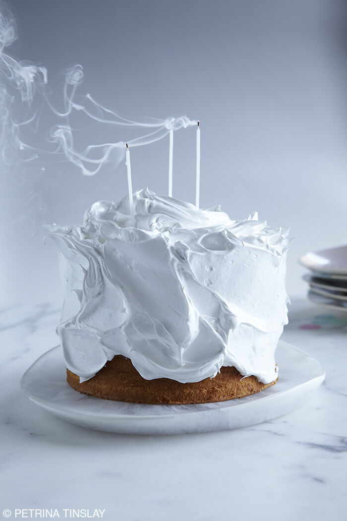 Cake with white frosting and extinguished candles, celebrating National Cake Day with Tiptree Cake Awards.
