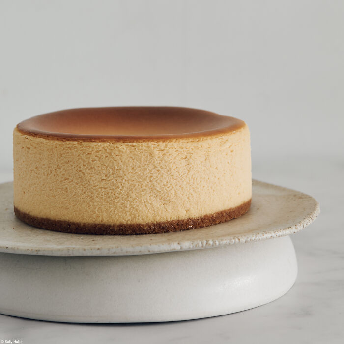 A beautifully baked sponge cake on a ceramic plate, celebrating cakes for the Tiptree Cake Awards.