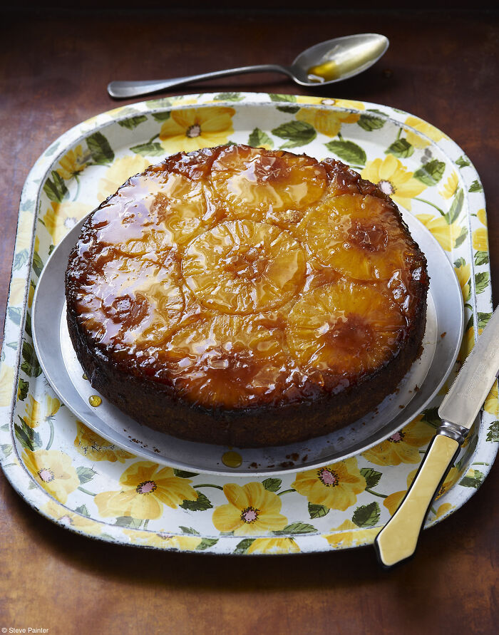 Glazed pineapple cake on a floral tray, captured by photographers celebrating National Cake Day with Tiptree Cake Awards.