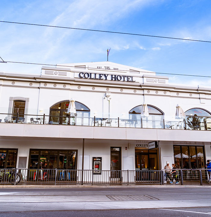 Colley Hotel exterior with patio seating, related to face tattoos incident.