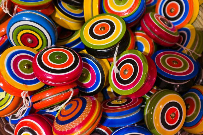 Colorful spinning tops piled together, representing trends that disappeared quickly after taking the internet by storm.