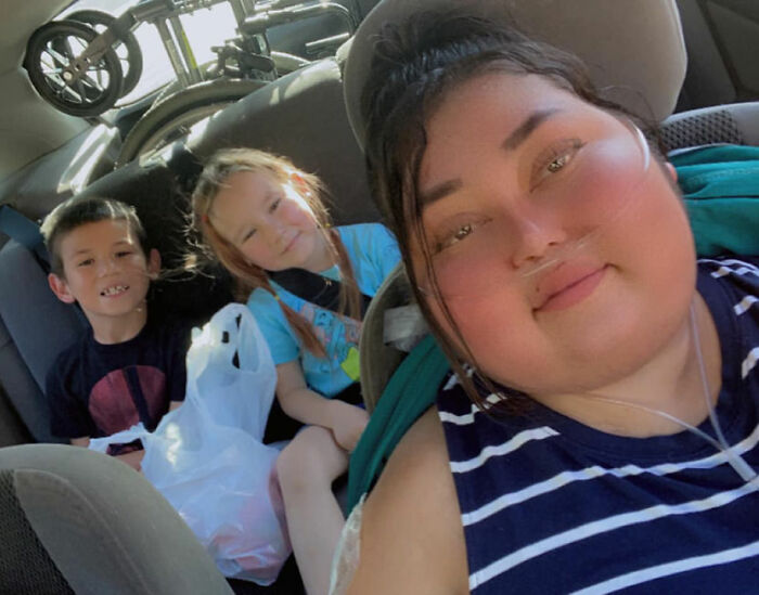 Single mom with her two children in a car, united on a journey of support after her terminal diagnosis. Single mom with her two children in a car, united on a journey of support after her terminal diagnosis.