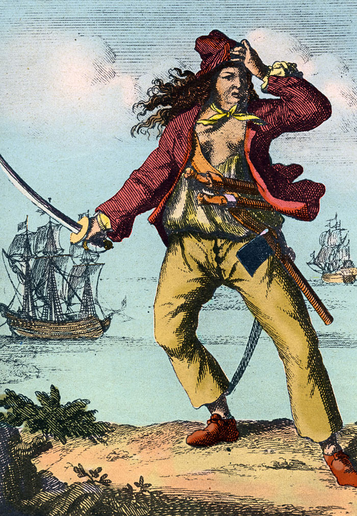 Illustration of a famous pirate wearing a red jacket and yellow pants, holding a sword with ships in the background on the ocean.