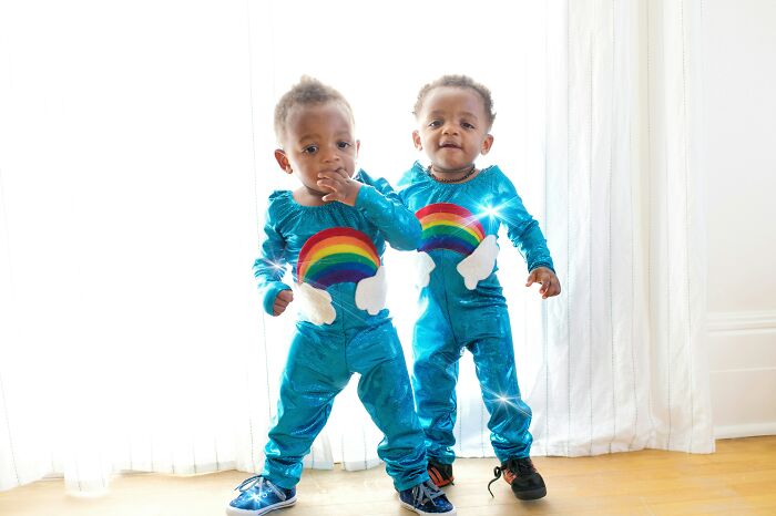 Two toddlers wearing matching rainbow outfits, illustrating mind-blowing coincidences that seem impossible to be real.