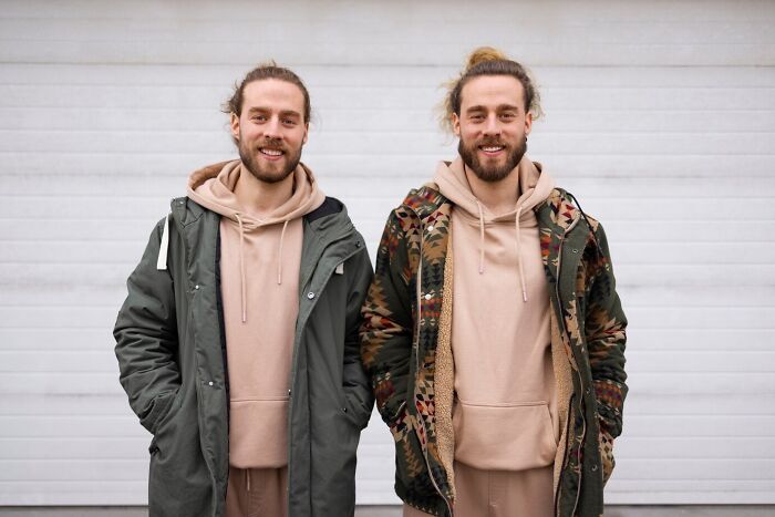 Two men with matching hairstyles and similar outfits, illustrating mind-blowing coincidences that seem impossible to be real.