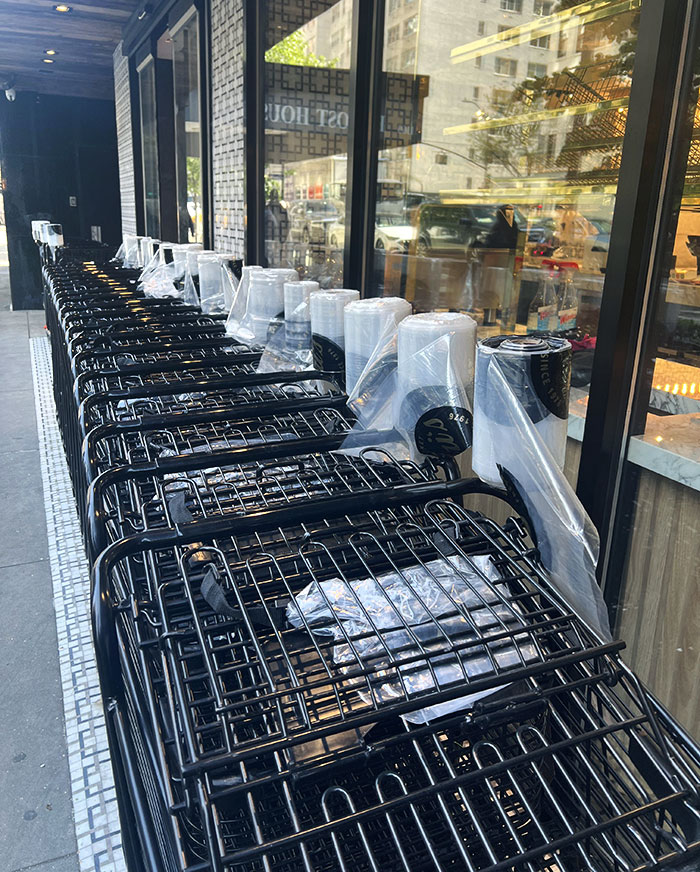 These Shopping Carts Have Produce Bags Attached To Them