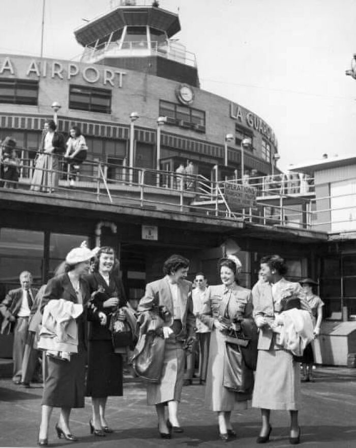 Five Female Journalists Smile As They Walk On The Airport Runway To Board A Vacation Flight After Winning The Annual 'Prettiest Newspaperwoman' Contest