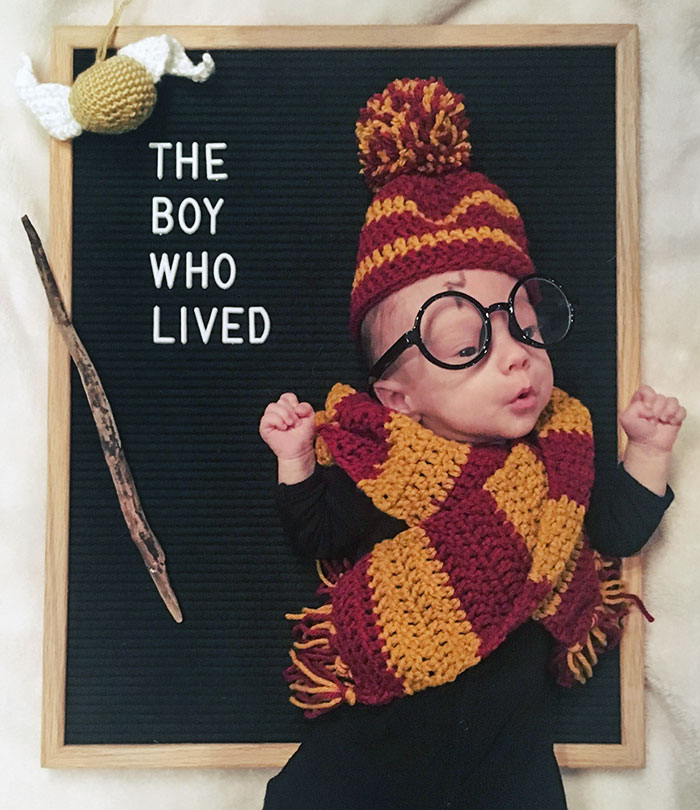 Baby dressed in a Hogwarts-inspired Halloween costume with glasses, scarf, and hat for kids' Halloween costume ideas.