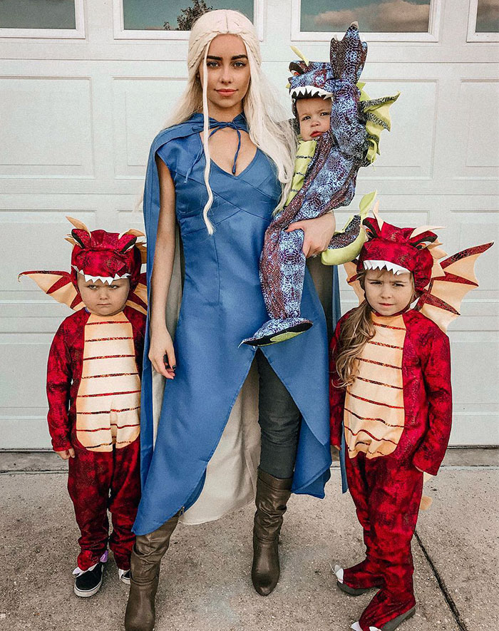 Woman in blue costume with three kids dressed in red dragon outfits for kids Halloween costume ideas that worked like magic.