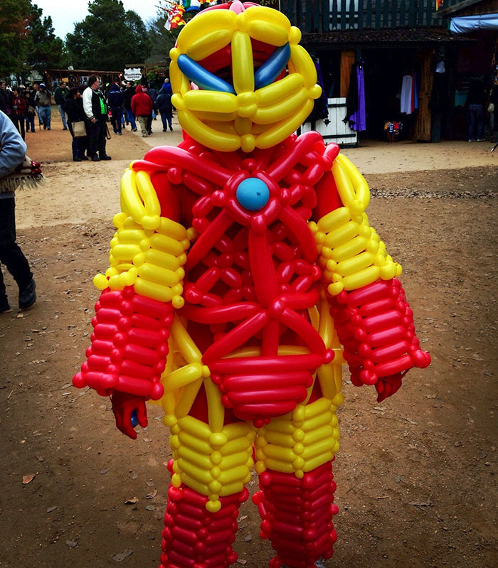 Child in a creative kids Halloween costume made of red and yellow balloons, showcasing unique costume ideas that worked like magic.