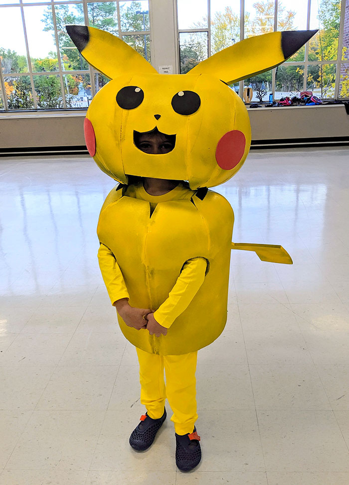 Child dressed in a bright yellow Pikachu costume, showcasing creative kids' Halloween costume ideas that worked like magic.