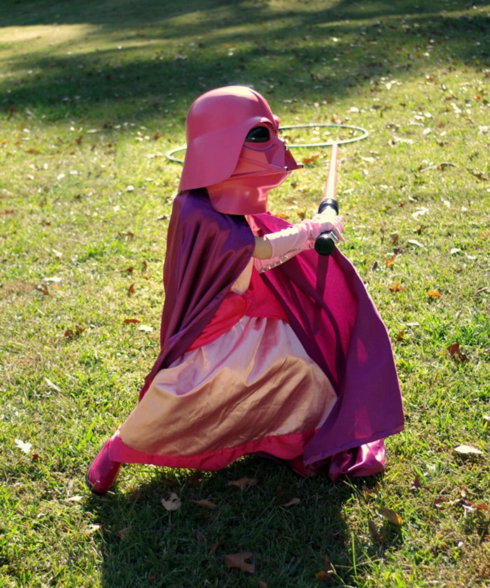 Child in a creative Halloween costume playing outdoors on grass, showcasing unique kids' Halloween costume ideas.