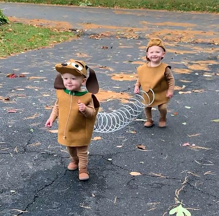 Two toddlers dressed in creative Halloween costumes, resembling a slinky dog, showcasing kids' Halloween costume ideas.