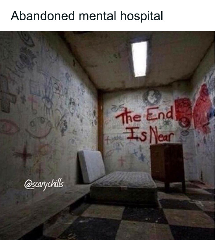 Abandoned mental hospital room with graffiti and a mattress, capturing a creepy and unsettling atmosphere.