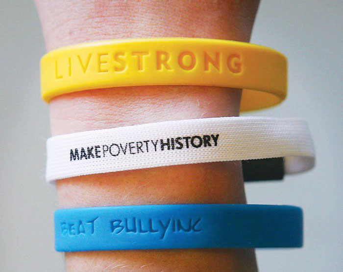 Yellow, white, and blue awareness wristbands representing popular trends that disappeared quickly on the internet.