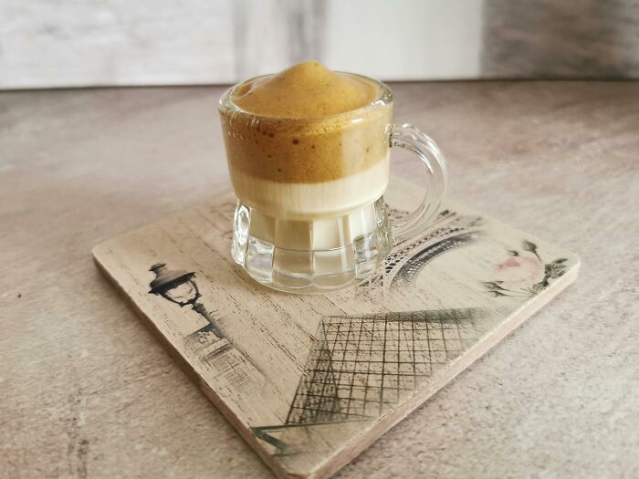 Trendy dalgona coffee in a clear glass mug showcasing the viral internet trend that quickly disappeared after gaining fame.